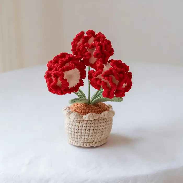 Plante en pot de carnations en laine crochetée à la main